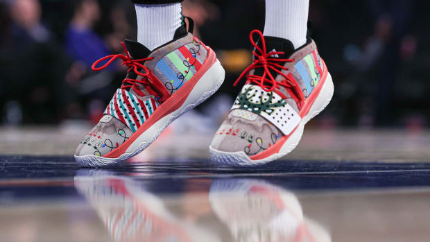 Milwaukee Bucks guard Damian Lillard's white, red, and black adidas sneakers.